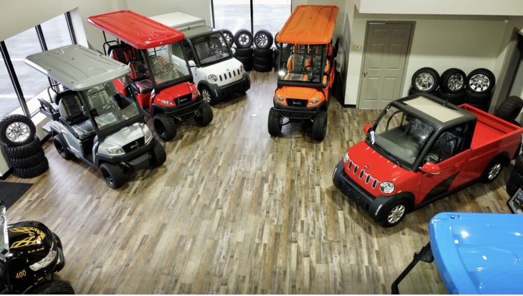 GreenGo Buggies golf carts and golf cars in red, white, and orange colors displayed at the showroom in Kernersville, NC.
